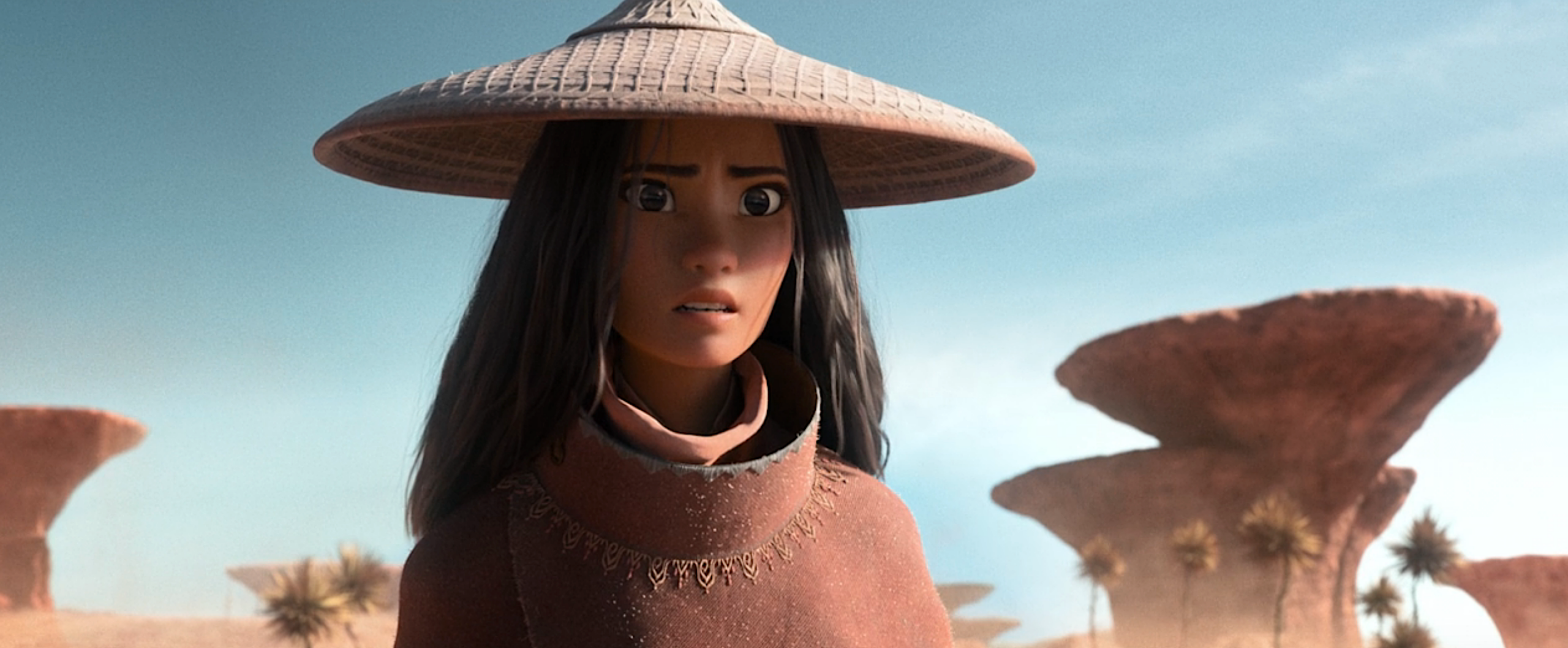 Raya from Raya and the Last Dragon, in a woven brown sun-hat and brown cloak, looks toward the horizon with a worried face