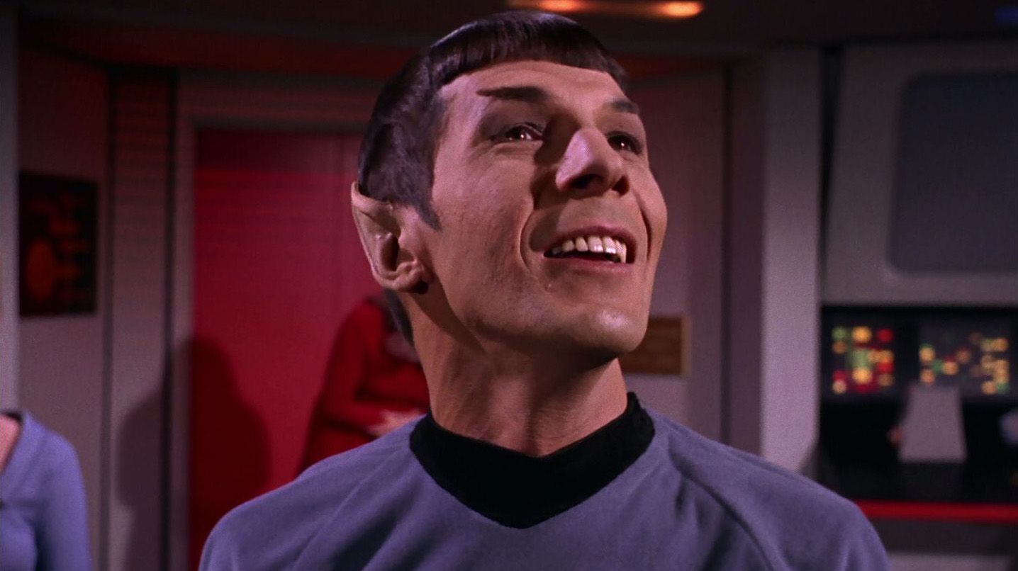 Leonard Nimoy as Spock, smiling and looking up in the original 1960s Star Trek series