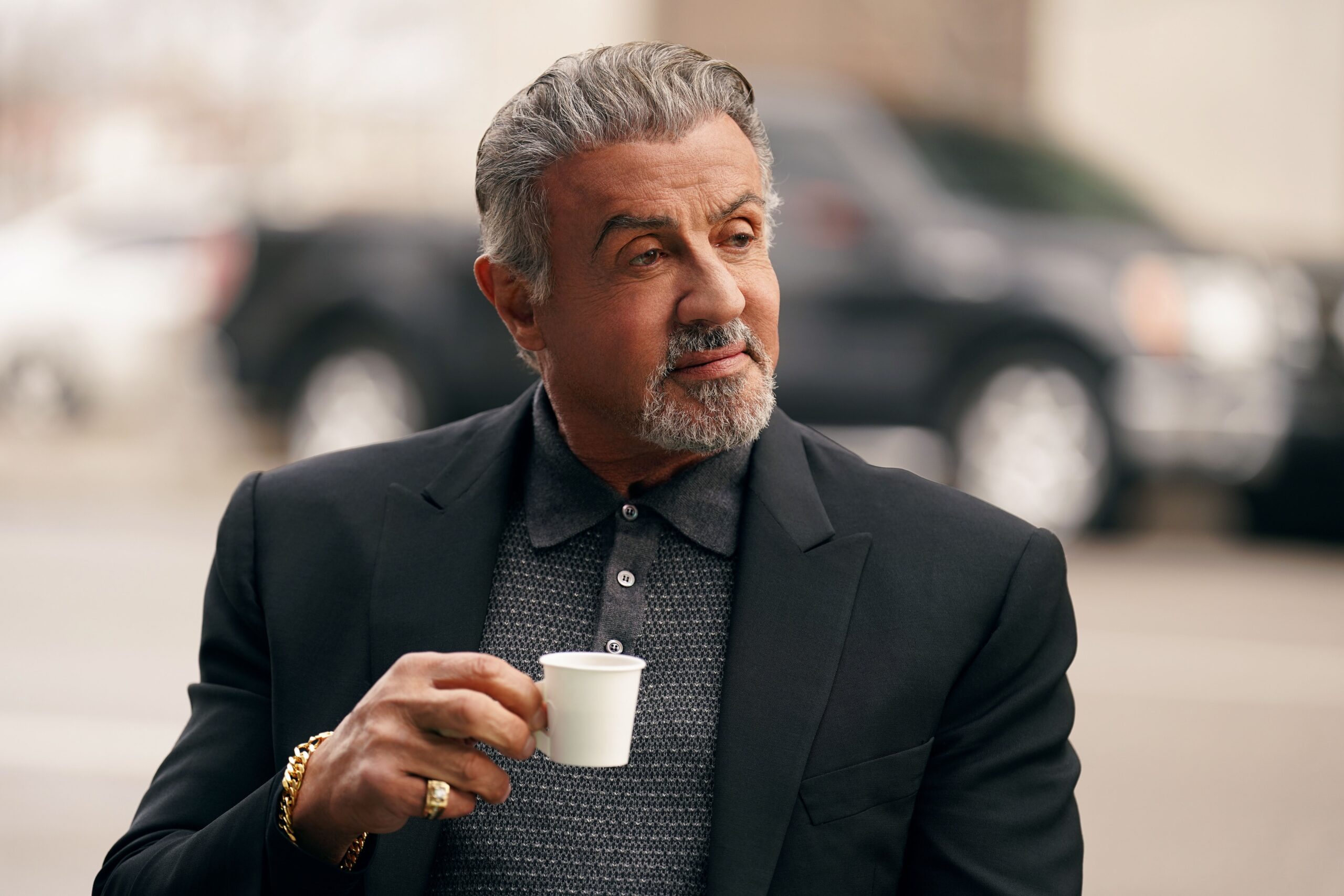 Sylvester Stallone sips a tiny tiny espresso mug in the Paramount Plus show Tulsa King