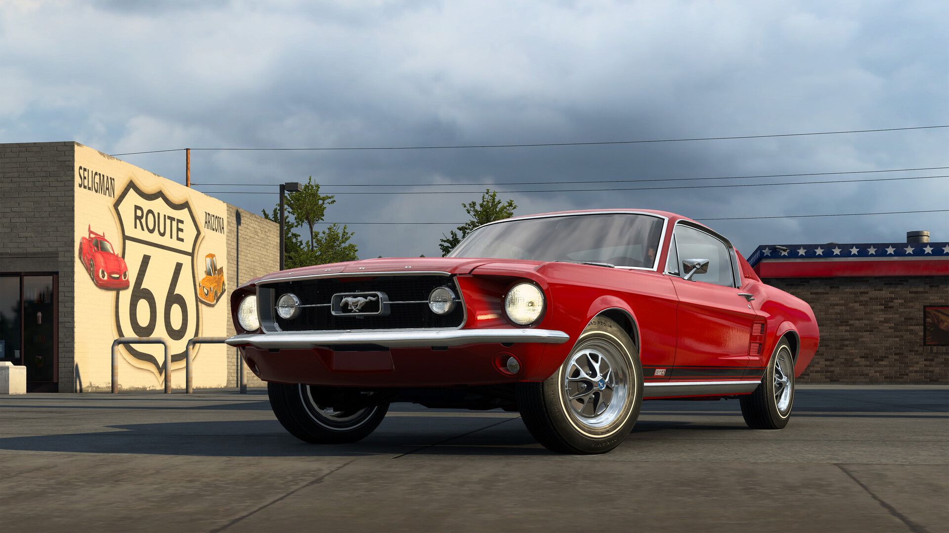 A lovely read 1967 Ford Mustang parked by a Route 66 mural