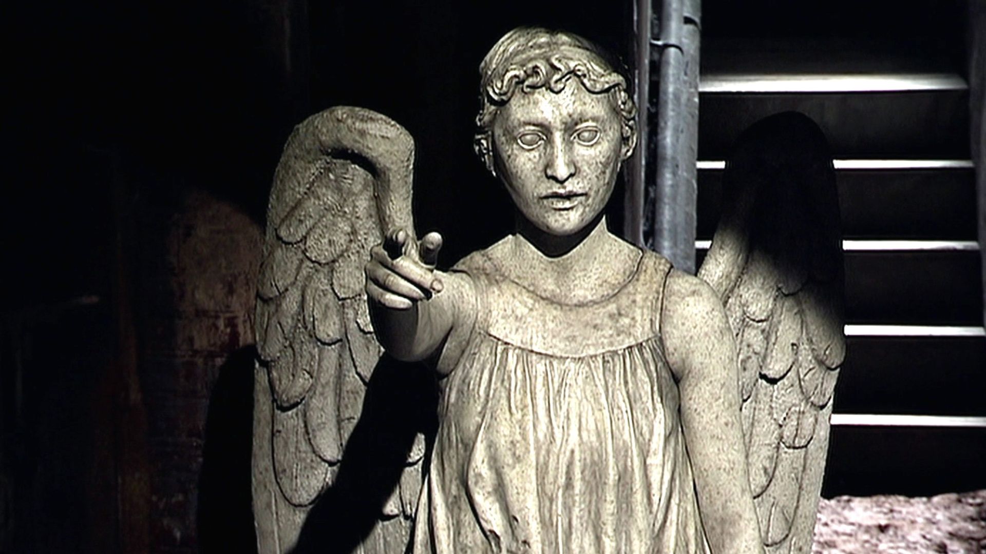 A Weeping Angel points at the camera.
