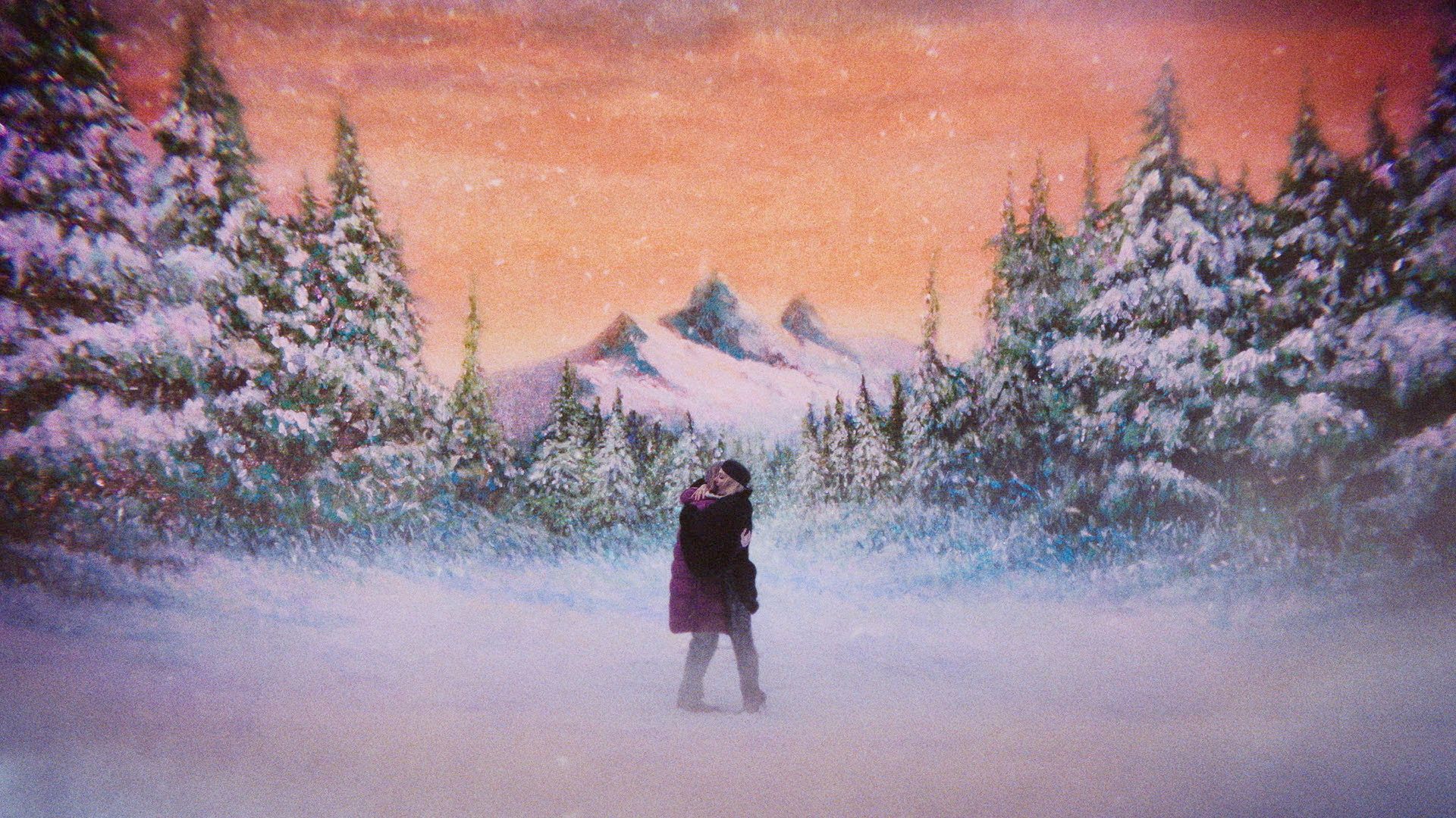 Two women embracing on a snowy landscape in Teenage Sex and Death at Camp Miasma