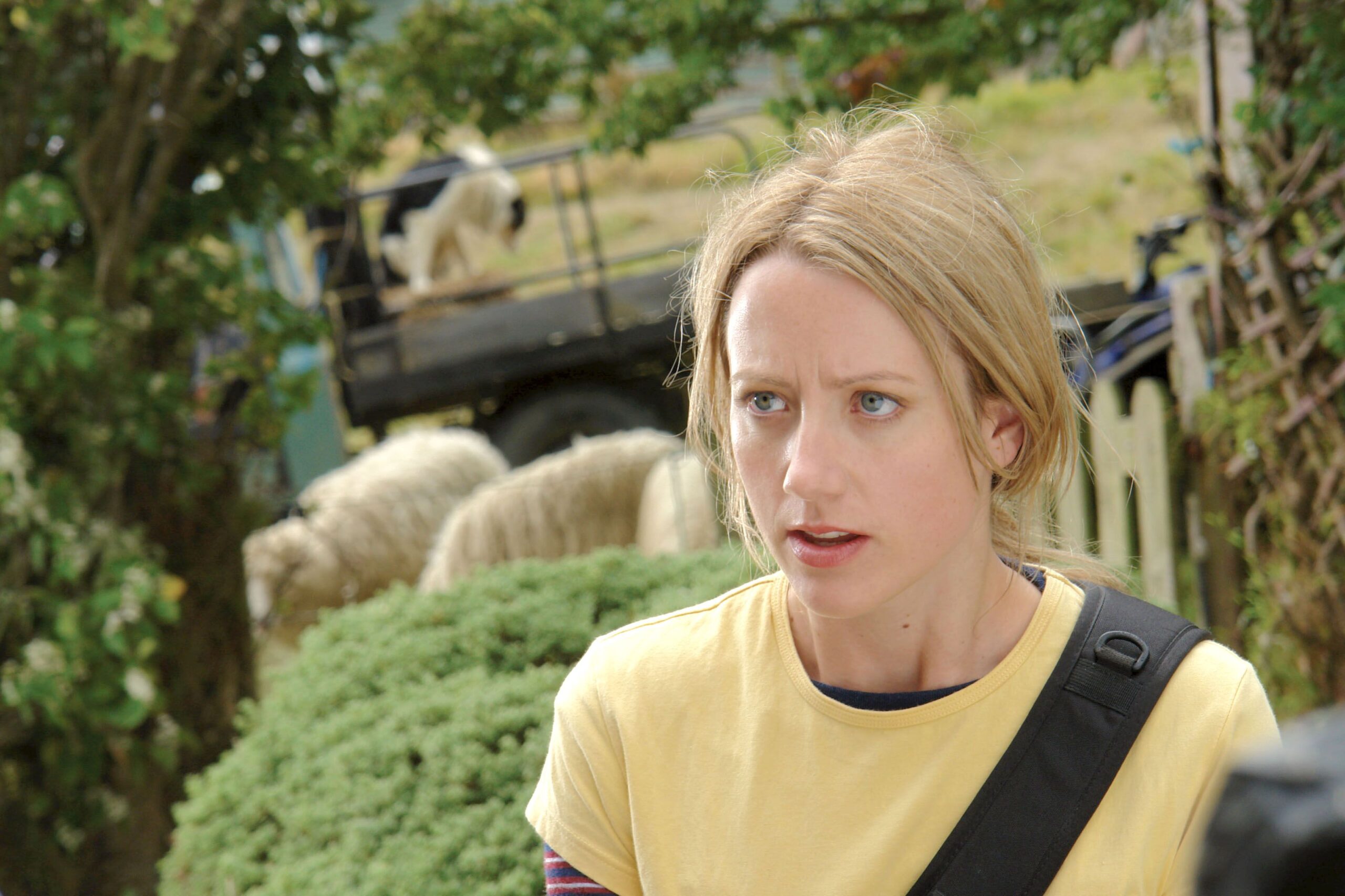 A woman in yellow looks exasperated.