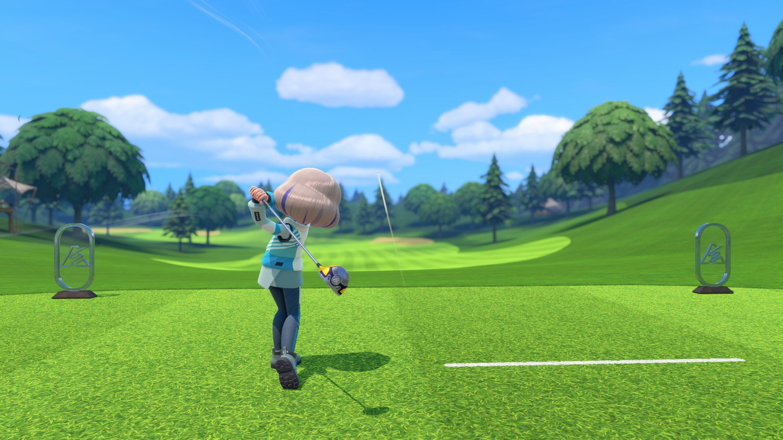 A golfer swings on the links