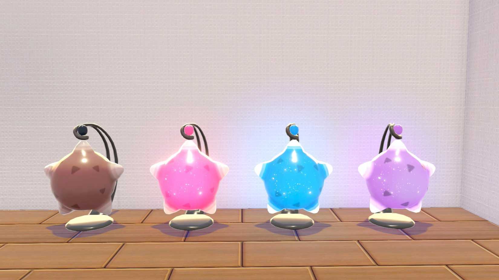 A display of four lamps that look like Minior in Pokopia, each with a different color: brown, pink, blue, and violet.