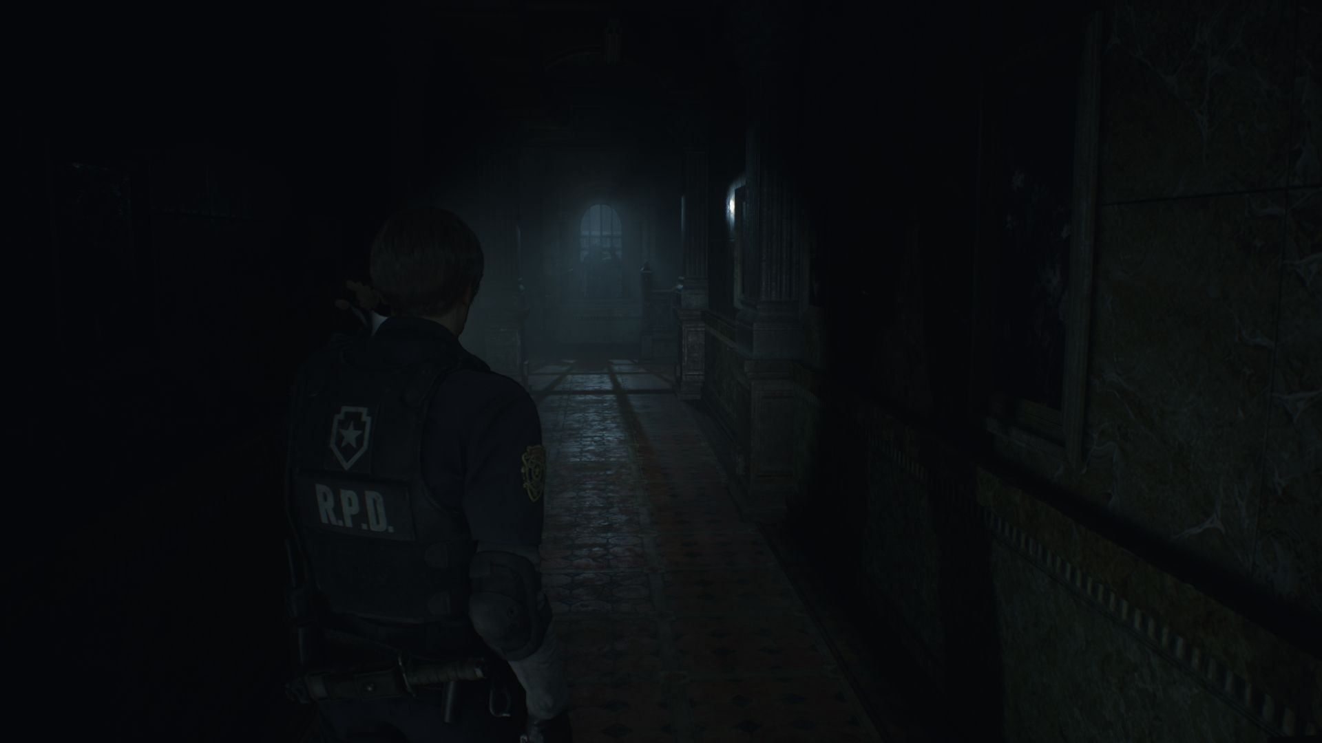 Leon in a dark hallway in Resident Evil 2