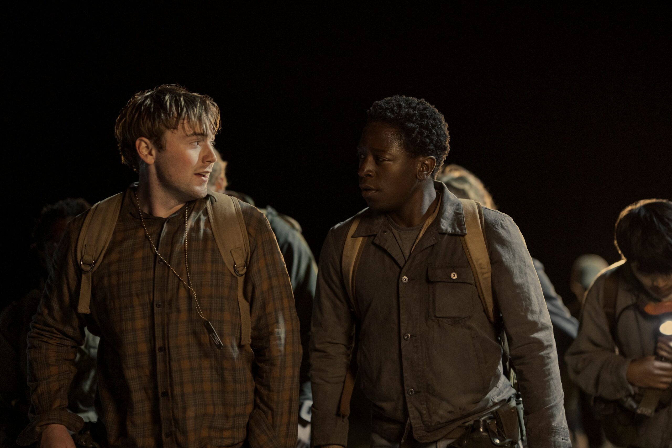 Cooper Hoffman as Garraty and David Jonsson as McVries in a night shot in The Long Walk