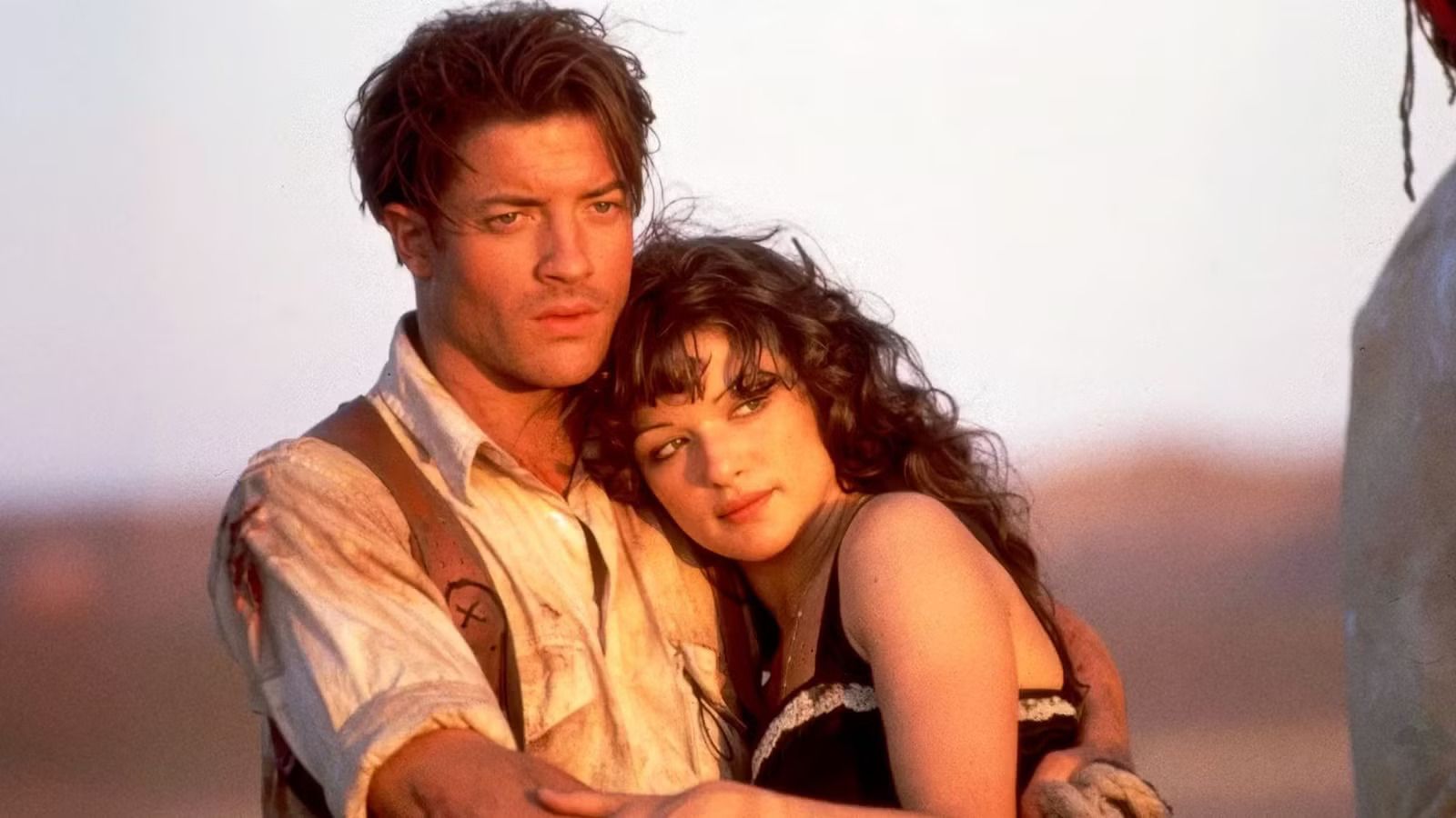 Image from The Mummy (1999) showing Brendan Fraser and Rachel Weisz embracing.