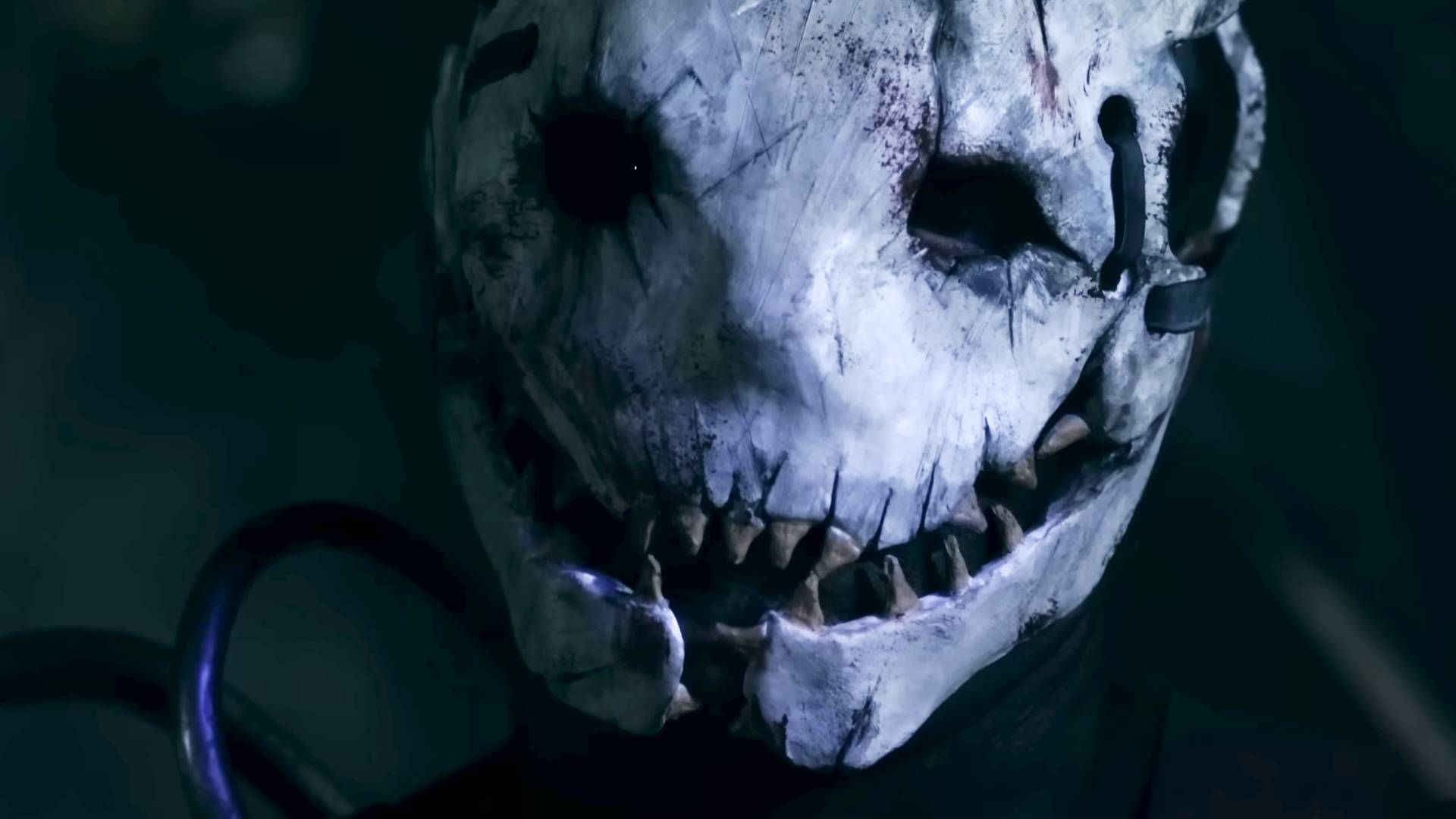 A shot of The Trapper from Jared Cline's 'The Trapper' short film. It shows a bone-white mask, its features pulled into a jagged, toothy grin.