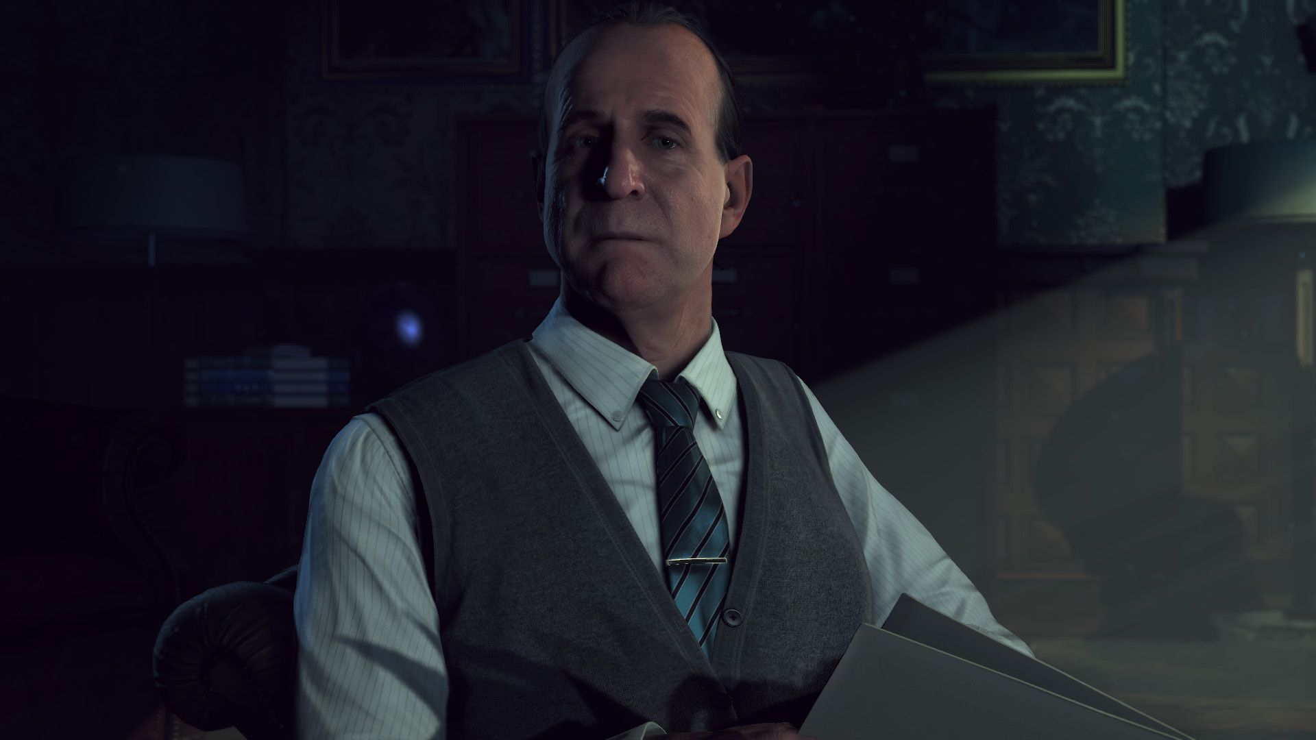 Dr. Alan Hill staring towards the camera in Until Dawn. He’s wearing a vest and tie.