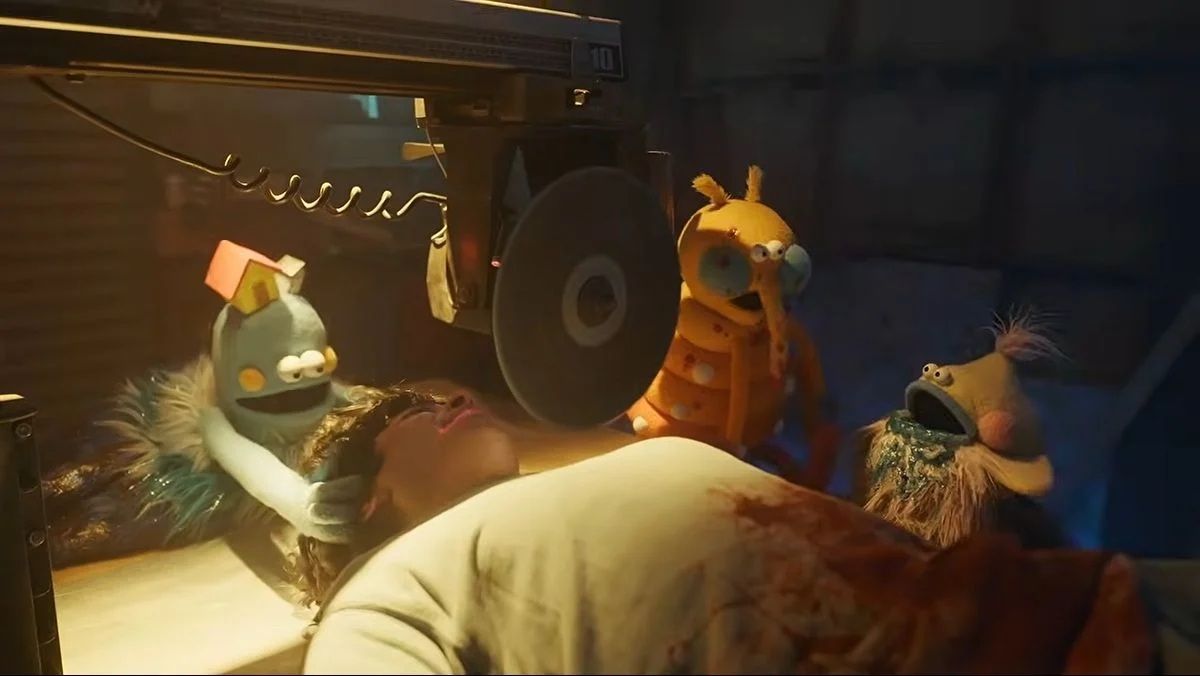 Puppets manhandling a man in V/H/S Mixtape